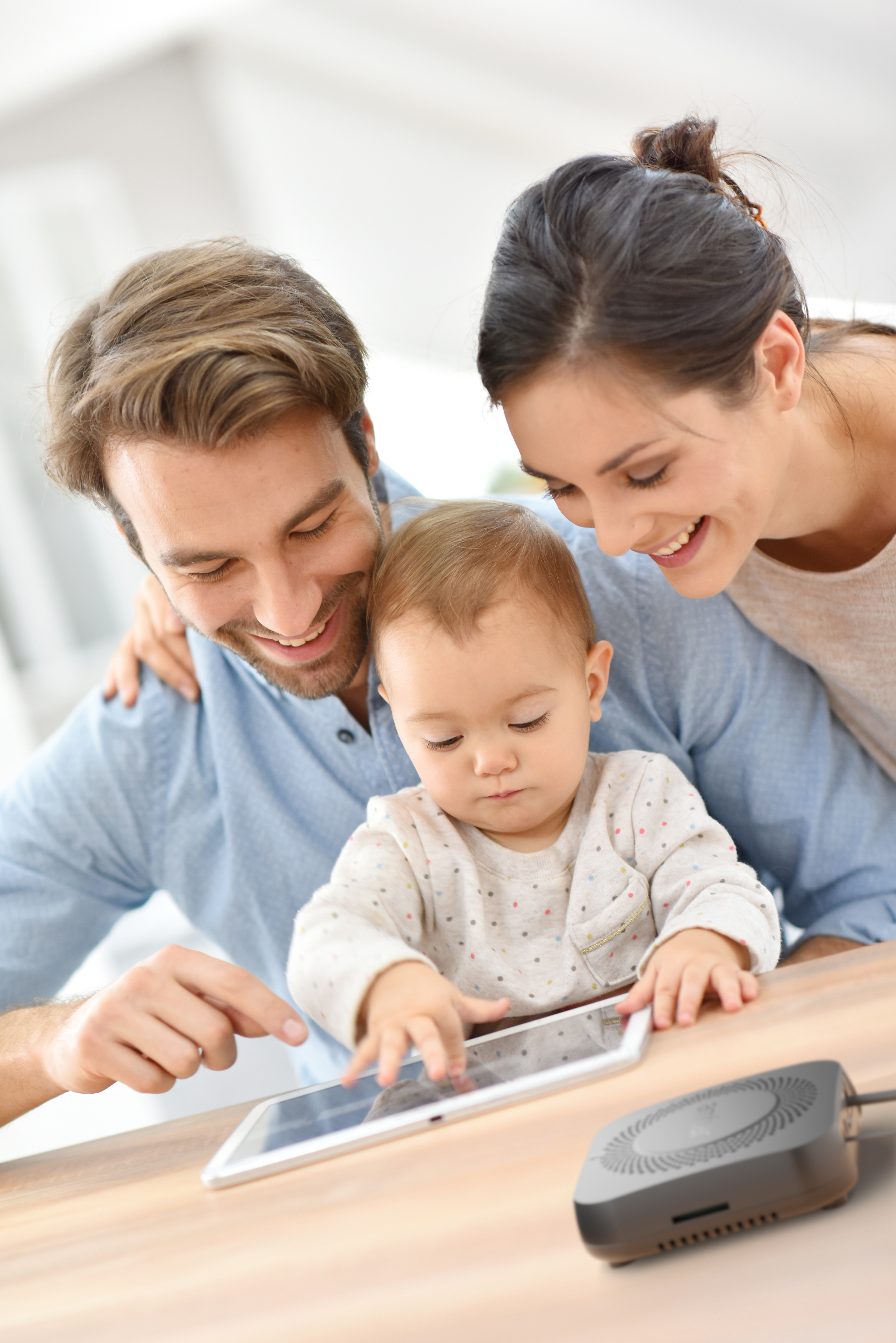 Two parents and their daughter using a tablet connected to AmberX