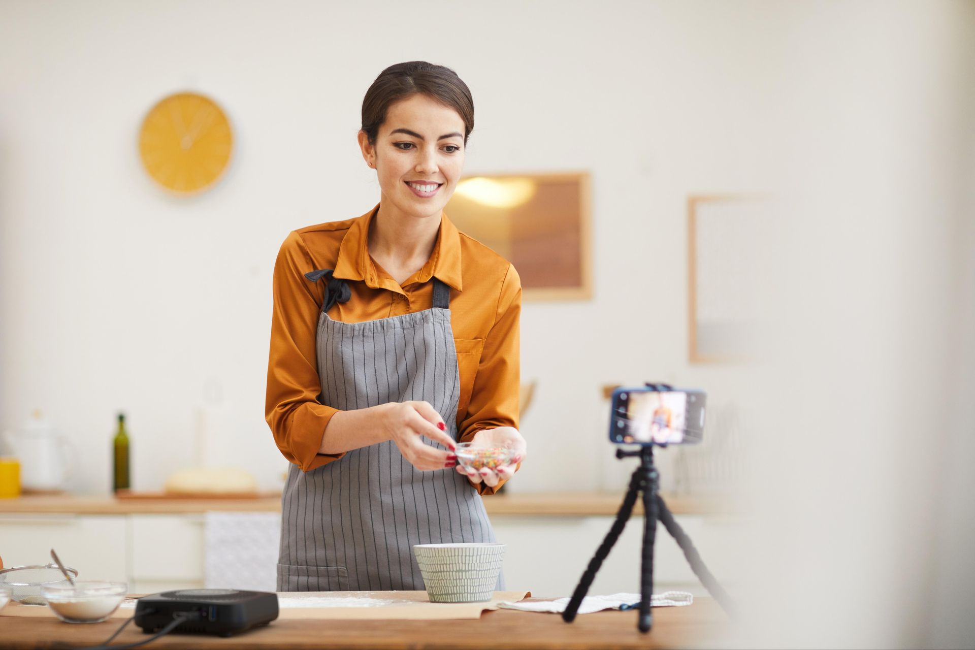 Woman recording a recipe with her phone connected to AmberX